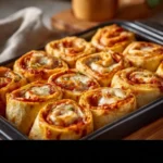 Delicious pizza roll-ups filled with cheese and sauce served on a plate