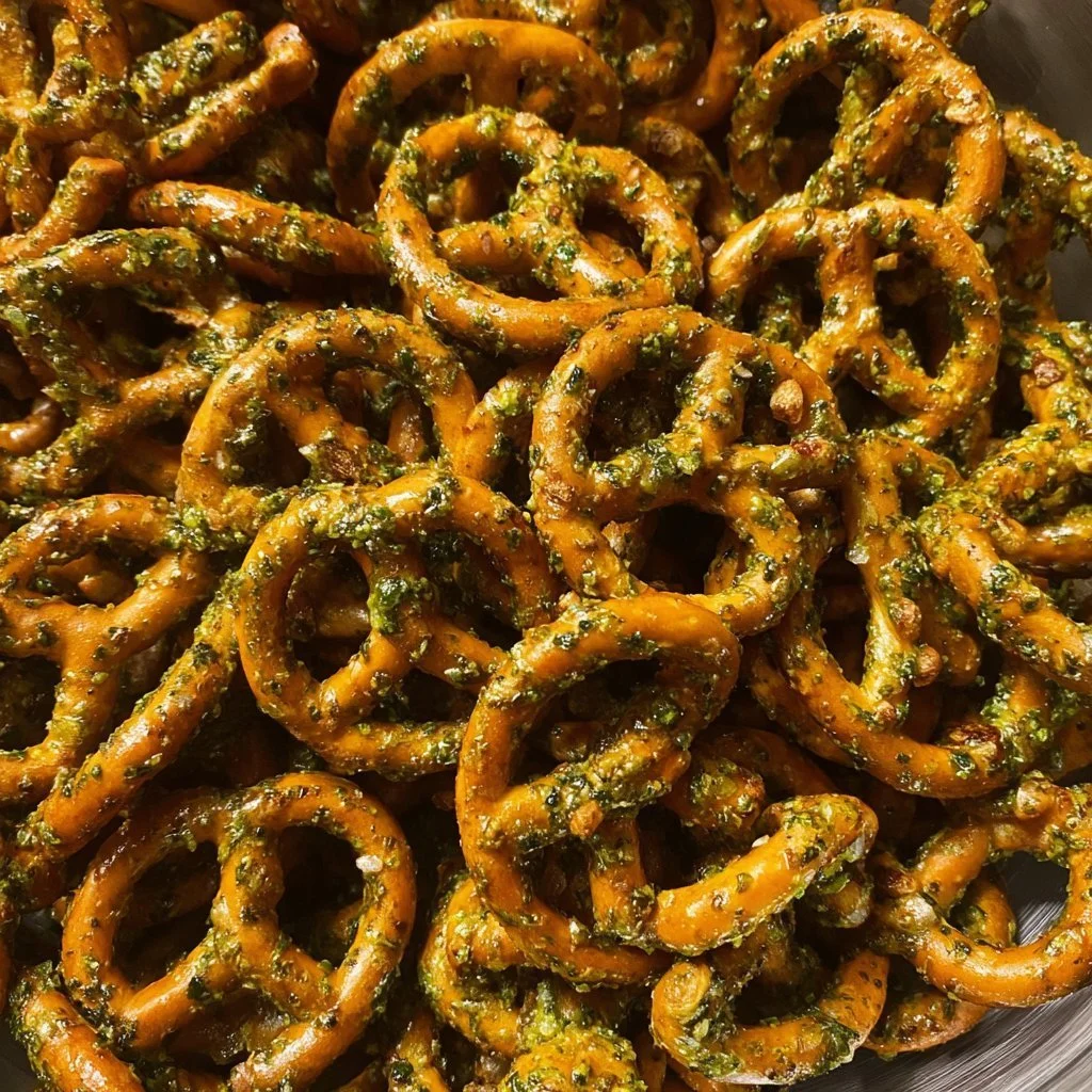 A bowl of flavorful marinated pretzels garnished with herbs.