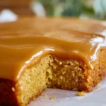 Delicious caramel cake with creamy caramel icing on a white plate