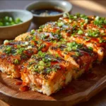 Delicious Spicy Salmon Sushi Bake served with fresh garnishes