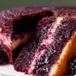 Dreamy blackberry velvet cake topped with fresh blackberries.