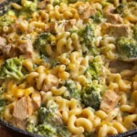 Cheesy Chicken Broccoli Mac served in a bowl with broccoli and chicken pieces.