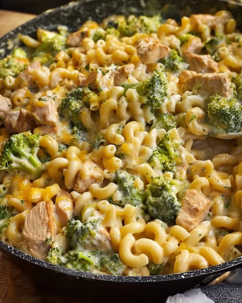Cheesy Chicken Broccoli Mac served in a bowl with broccoli and chicken pieces.