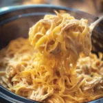 Delicious bowl of Crockpot Chicken and Noodles with fresh herbs