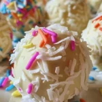 No-Bake Coconut Cream Easter Balls coated in coconut flakes.