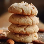 Freshly baked soft almond cream cookies on a cooling rack