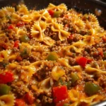 Delicious stuffed pepper pasta skillet cooked in a pan with colorful peppers and pasta