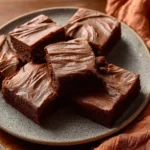 Delicious chocolate brownies with creamy chocolate frosting on top