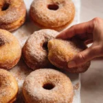 Freshly baked cinnamon sugar donuts on a plate