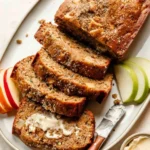 Sliced apple zucchini bread with a moist texture and apple chunks