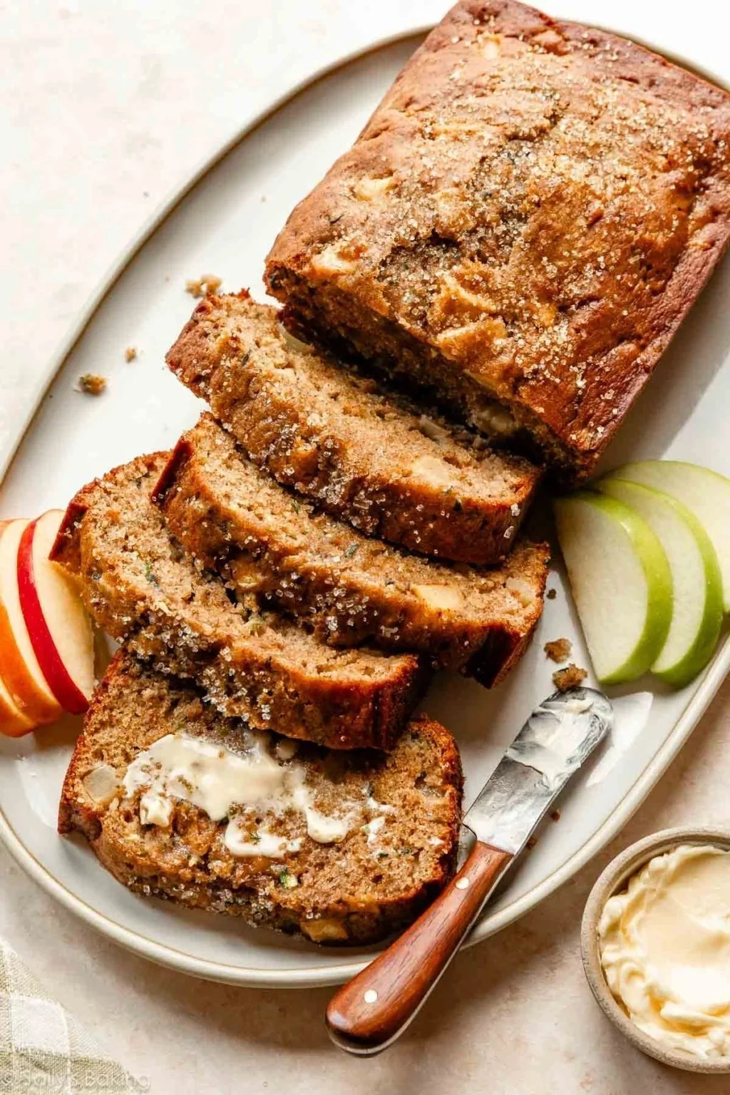 Sliced apple zucchini bread with a moist texture and apple chunks