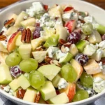 Colorful fruit salad drizzled with creamy sour cream dressing