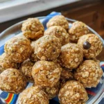 Homemade peanut butter balls on a plate, ready to enjoy as a delicious treat.