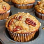 Freshly baked Pecan Banana Muffins on a wooden table